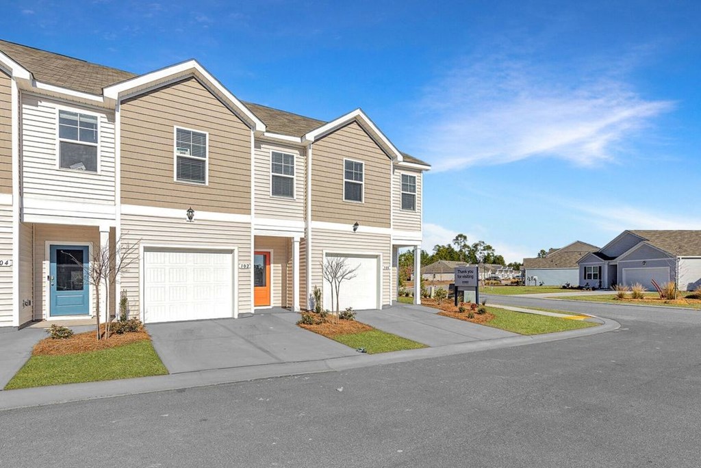 A row of houses with a clear blue sky above them.