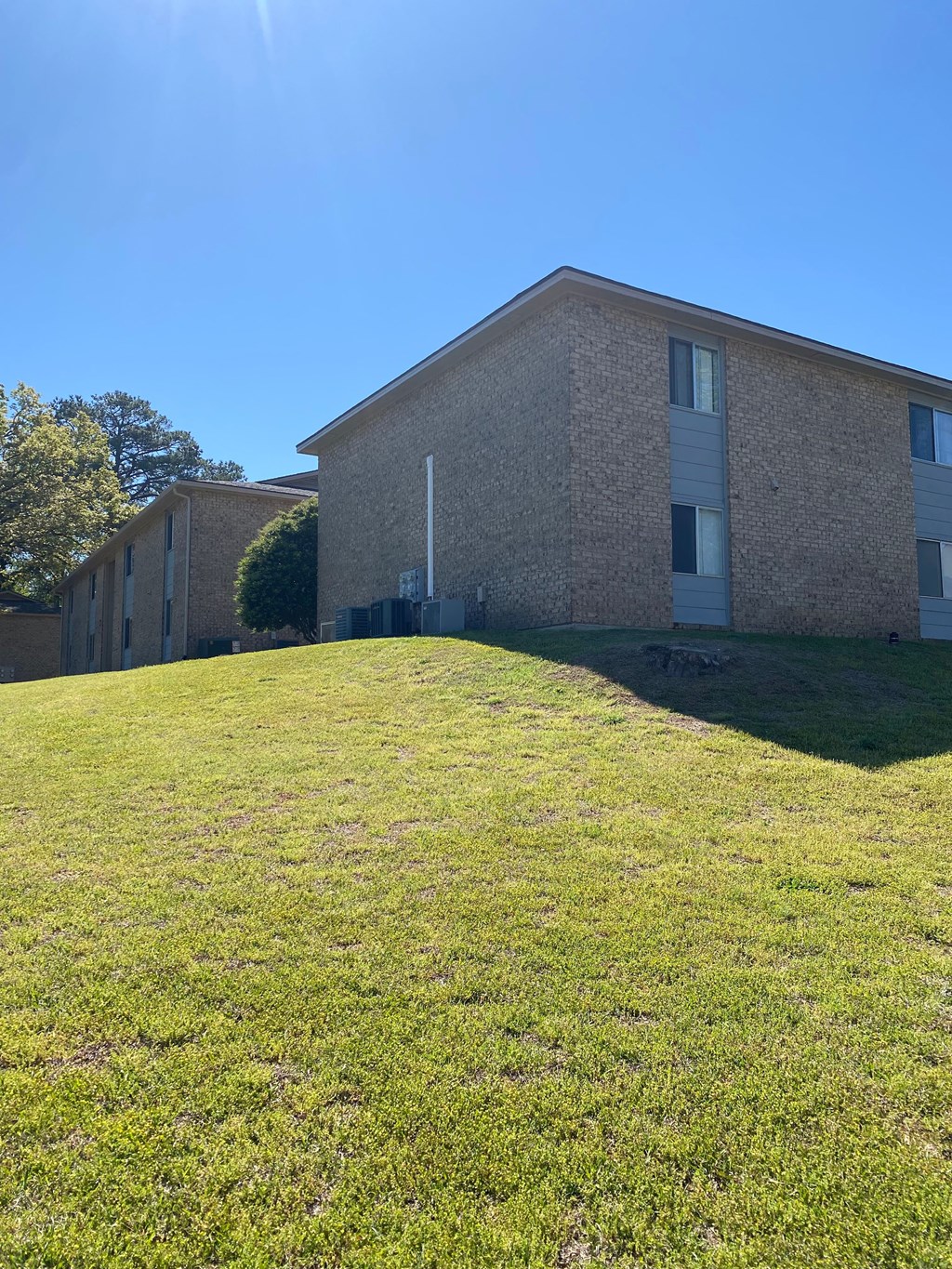 A building with a grassy slope in front of it.
