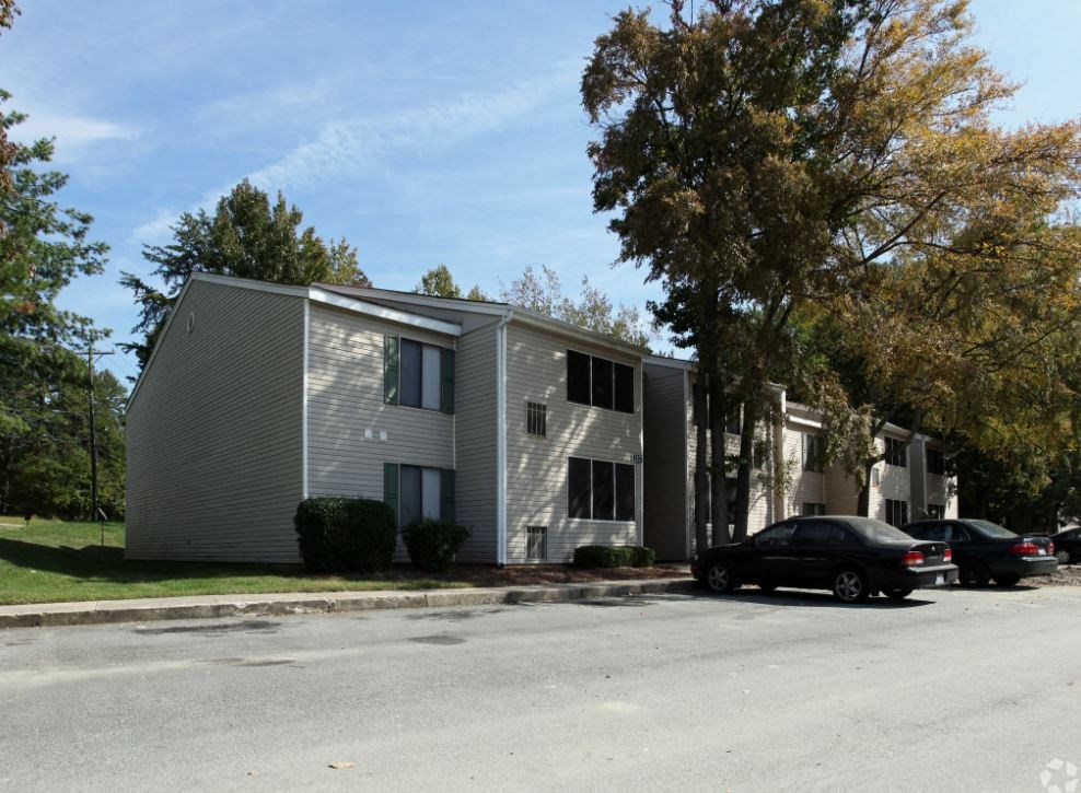 an apartment building with a car parked in front of it