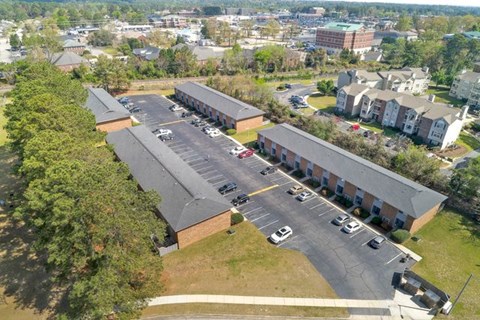 A parking lot is in front of a building.