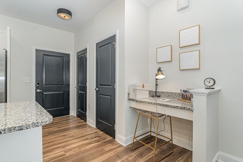 a bedroom with a medium sized bed and a desk with a chair in front of it