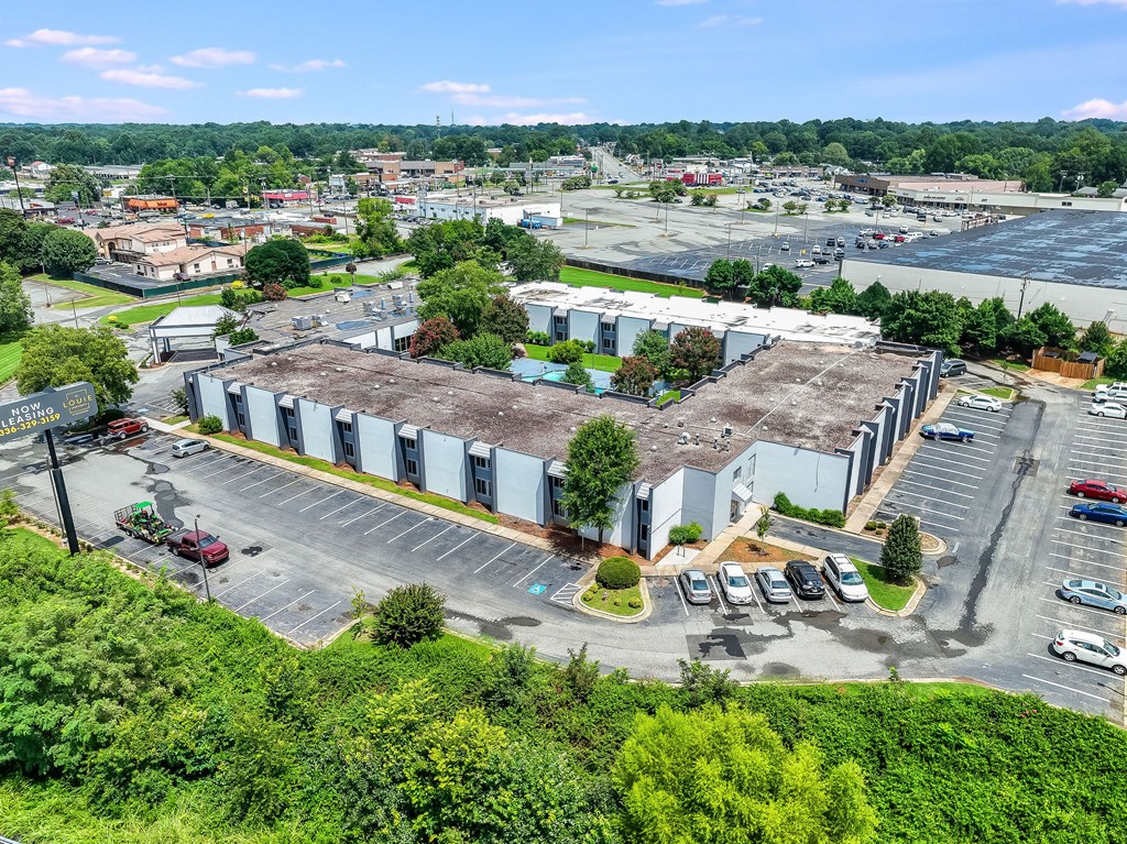 A large industrial building with a parking lot in front.
