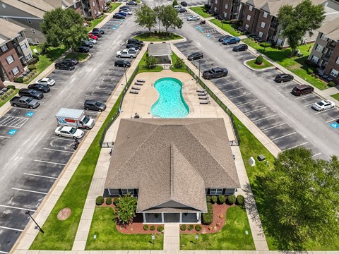 A swimming pool is located in the middle of a parking lot.
