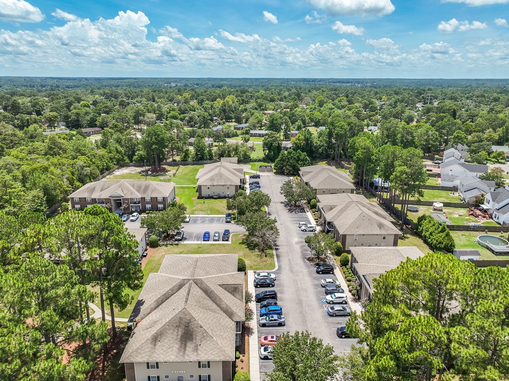 A bird's eye view of a residential area with houses and cars.