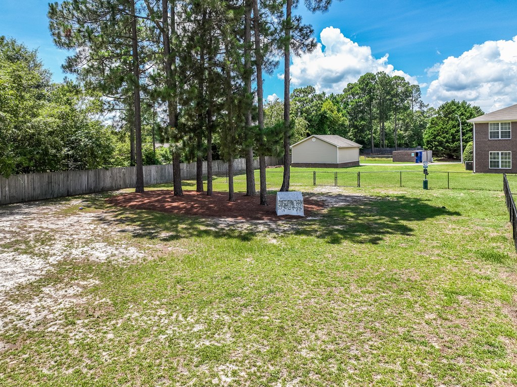 A yard with a sign in the middle of it.