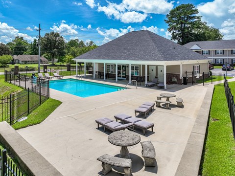 A pool area with a pavilion and lounging area.
