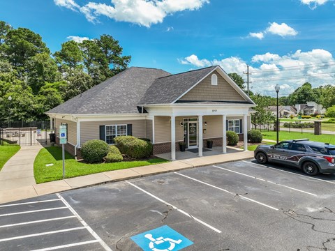 A small building with a parking lot in front of it.