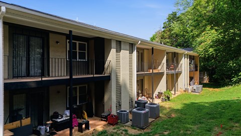 A sunny day at a residential complex with people enjoying the outdoors.