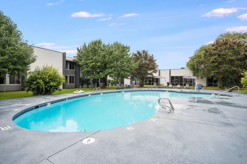 A large outdoor swimming pool with a slide.