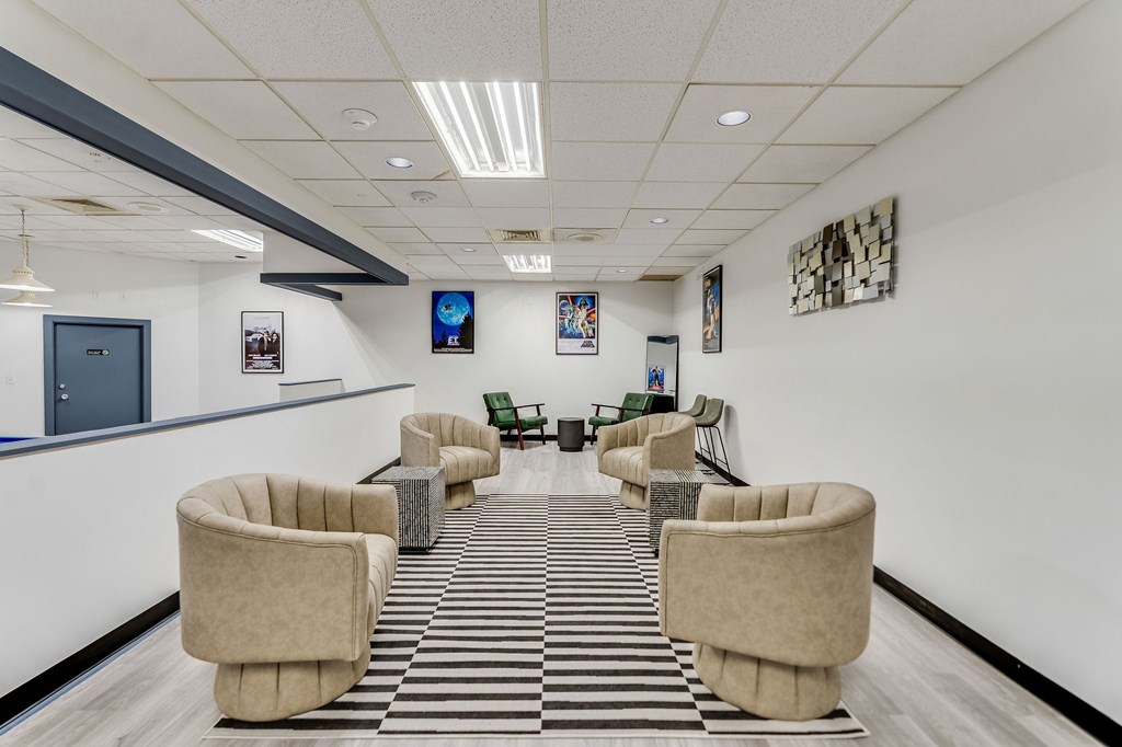 A row of tan chairs are lined up in a room.