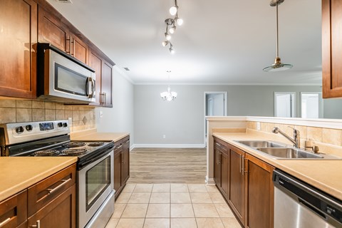A kitchen with wooden cabinets and stainless steel appliances.