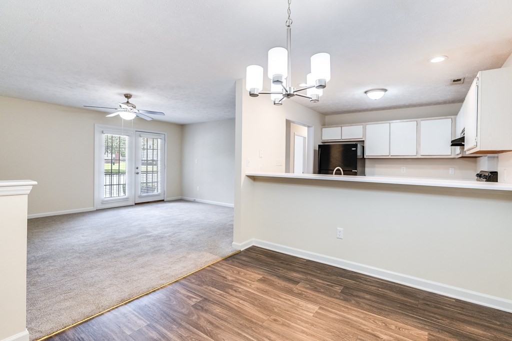 A room with a ceiling fan and a window.