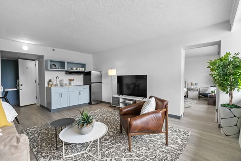 A living room with a brown leather chair and a white coffee table.