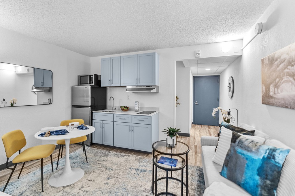 A modern kitchen with a dining table and chairs.