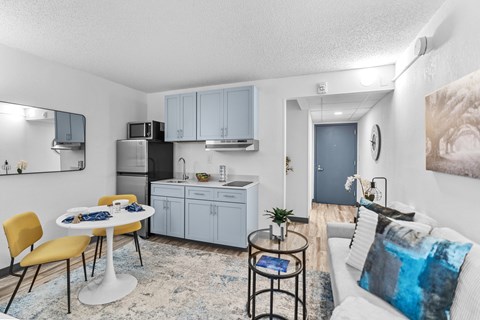 A modern kitchen with a dining table and chairs.