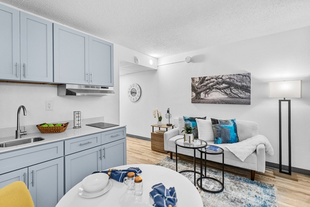 A modern kitchen with a dining table set for two.