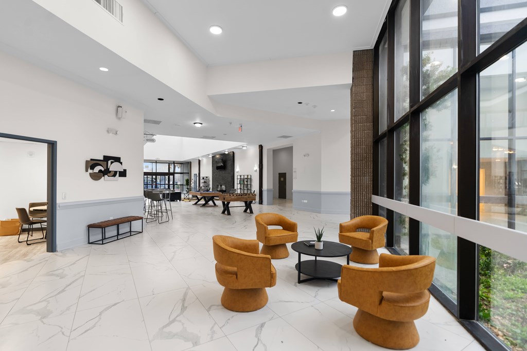 A modern living room with a white marble floor and a large window.