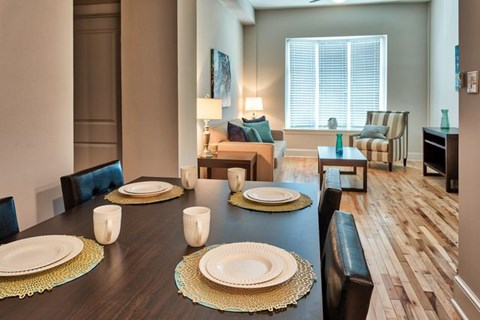 A dining room with a long table set for a meal.