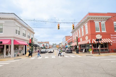 A street scene with a red building on the right.