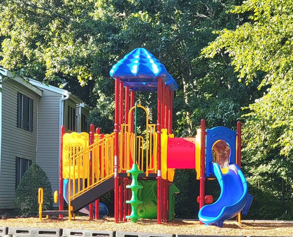 a child playing on a colorful playground
