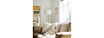 a living room with a couch and a lamp