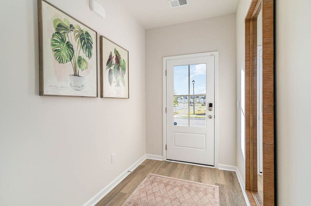 A white door with a glass window and a white frame.