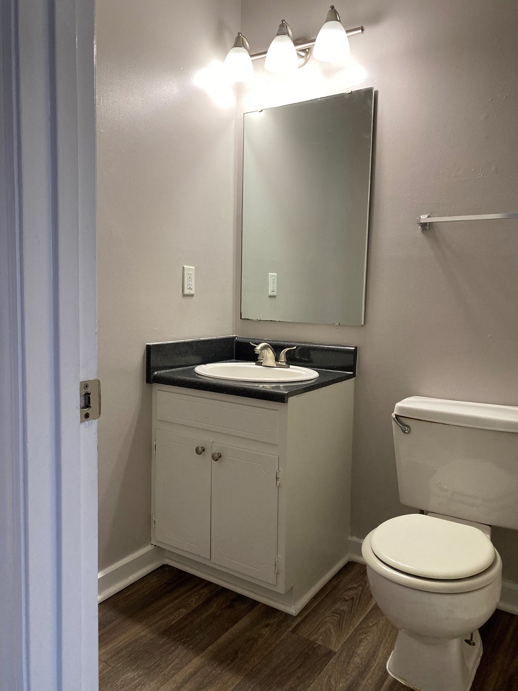 a bathroom with a toilet and a sink and a mirror