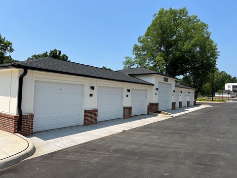 a row of garages in front of trees
