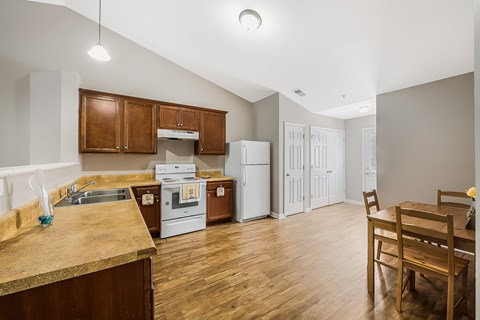 A kitchen with wooden cabinets and a white fridge.