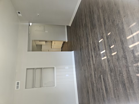 A room with a white ceiling and a wooden wall.