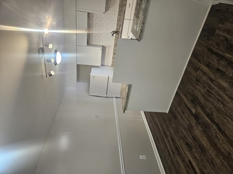 A bathroom with a toilet, sink, and mirror.