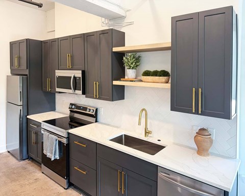 A kitchen with dark brown cabinets and a white countertop.