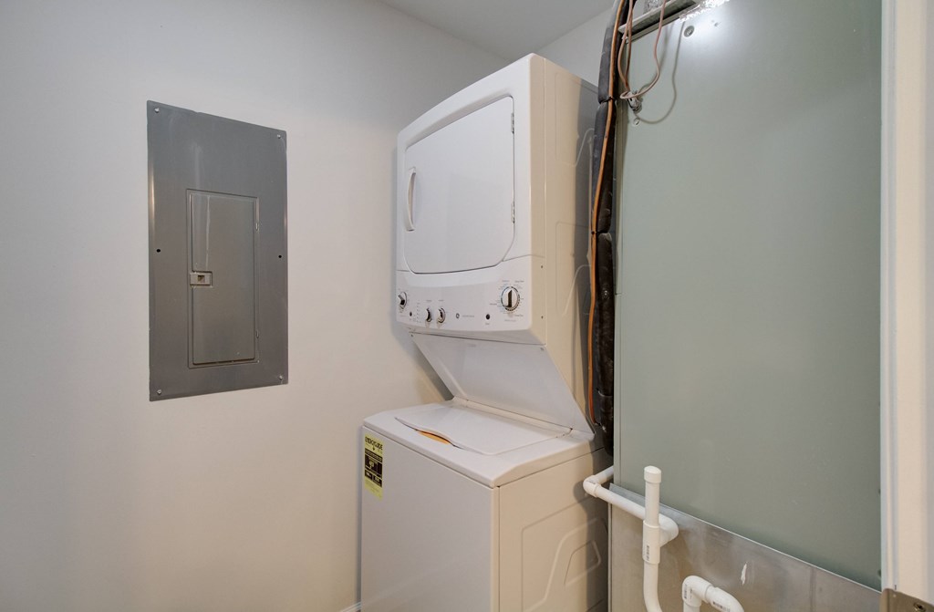 A white washing machine in a small room.