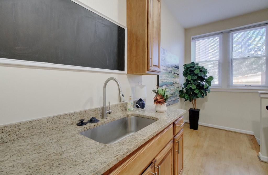 A kitchen with a sink and a window.