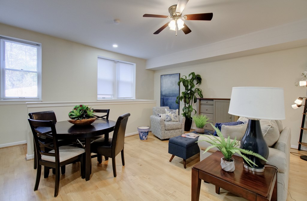A dining room with a table and chairs.