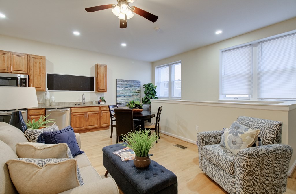 A living room with a couch, chair, and table.