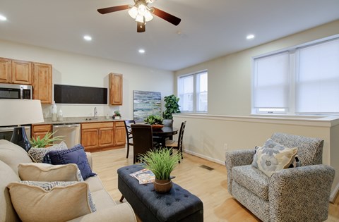 A living room with a couch, chair, and table.