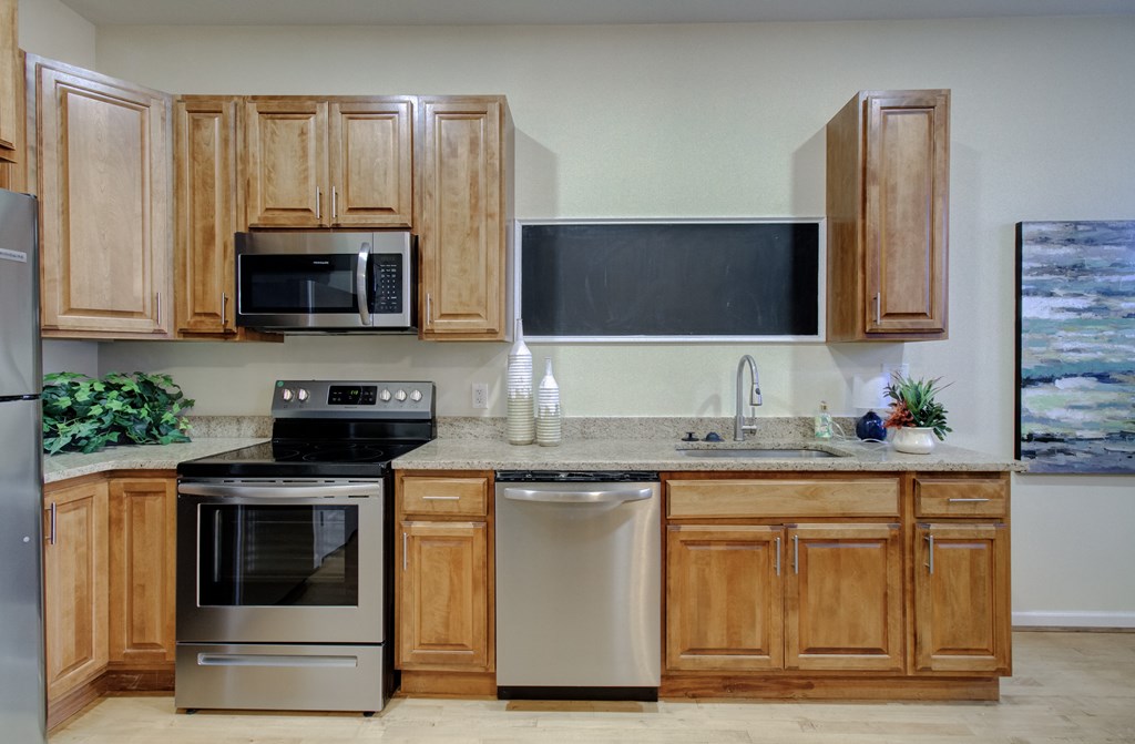 A kitchen with wooden cabinets and stainless steel appliances.
