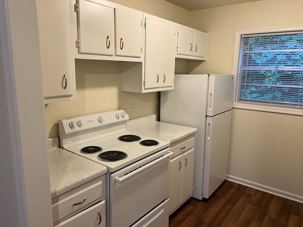 a kitchen with white appliances and white cabinets
