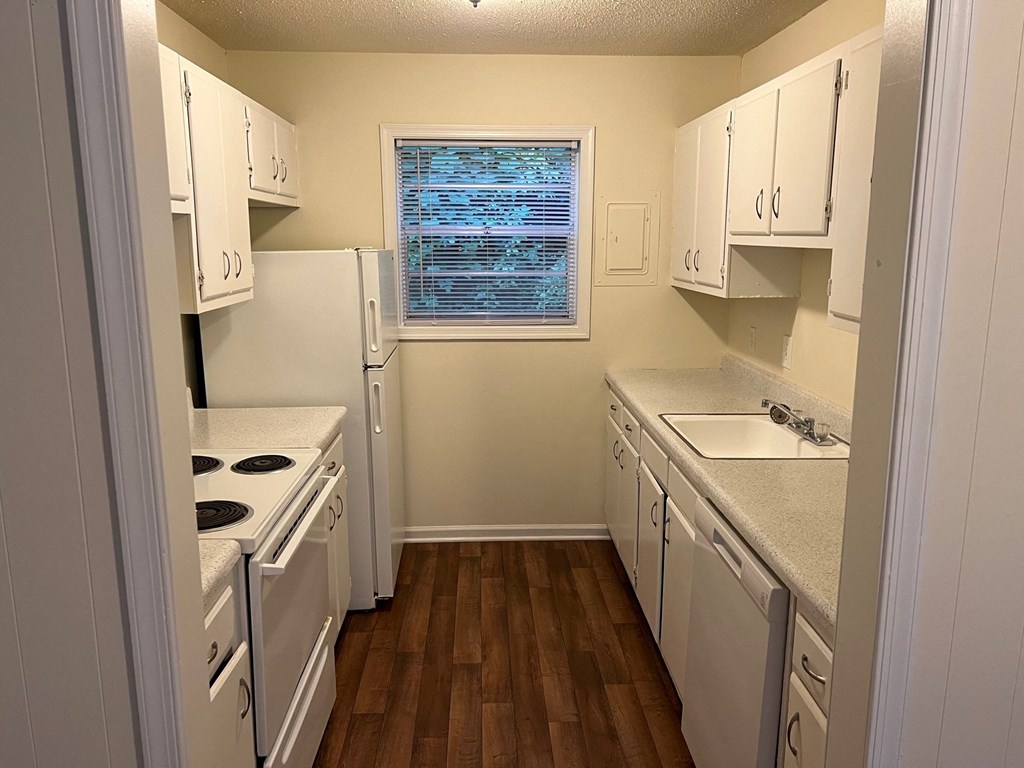 a kitchen with white appliances and white cabinets