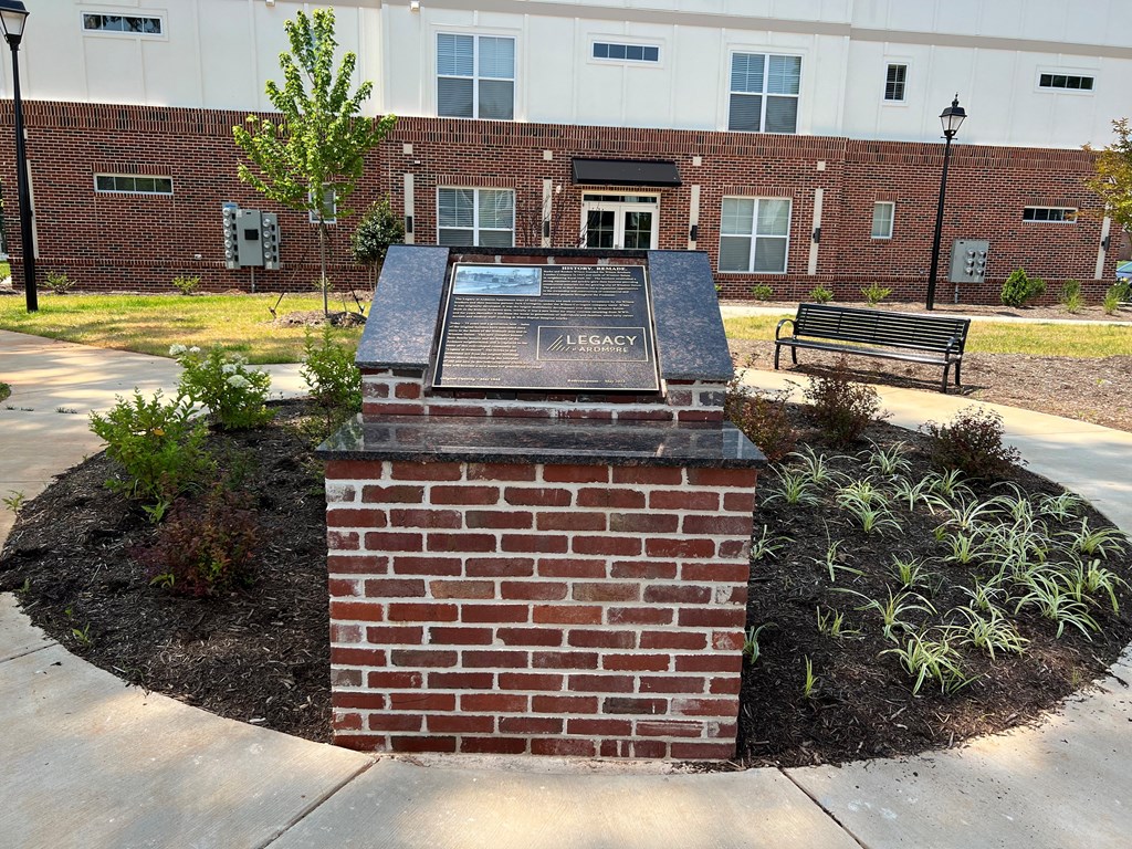 a monument in front of a brick building