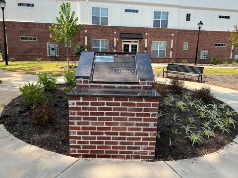 a monument in front of a brick building