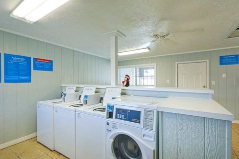 A row of washers and dryers in a laundromat.