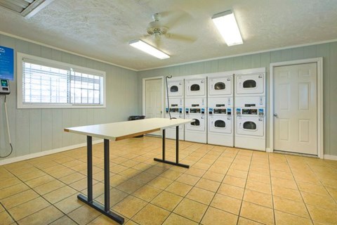 A room with a table and a fan.