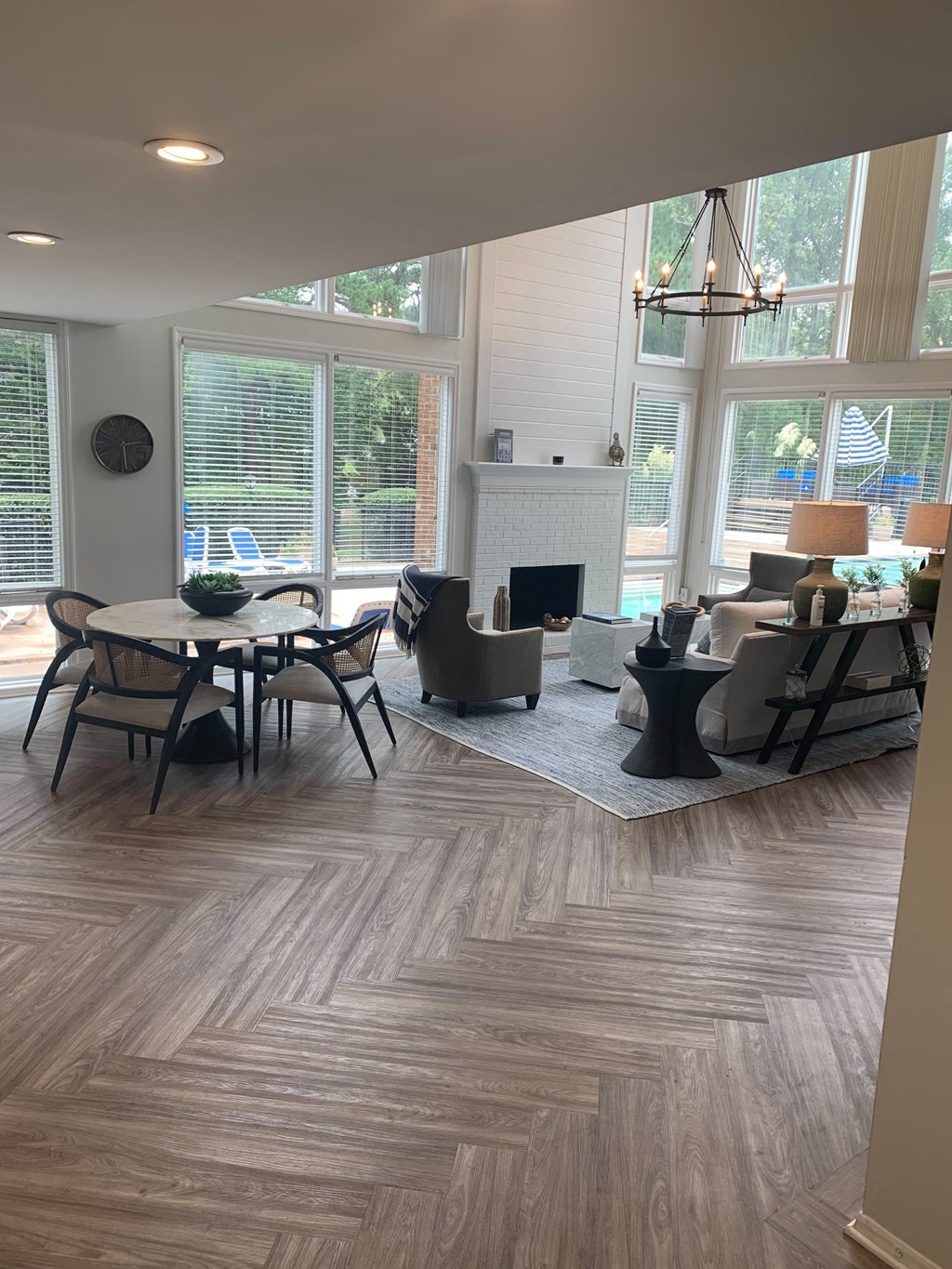 Leasing Office with view of fireplace, seating and pool visible through windows  at Huntington Apartments, North Carolina, 27560