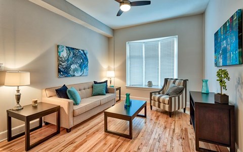 A living room with a couch, two chairs, and a coffee table.