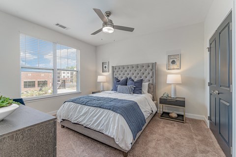 a bedroom with a bed and two windows