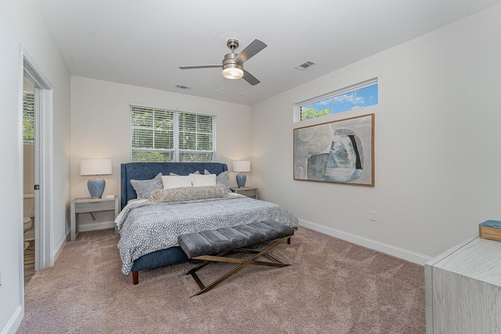 a bedroom with a bed and a ceiling fan