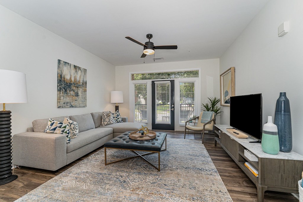 a living room with a couch a coffee table and a tv