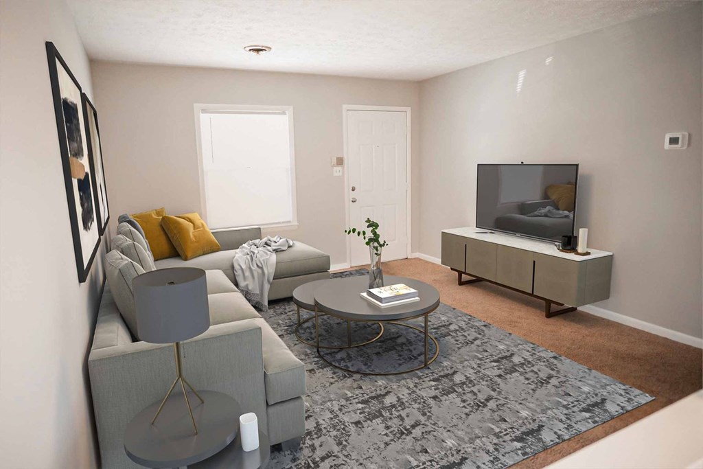 A living room with a grey couch, a grey coffee table, and a grey rug.